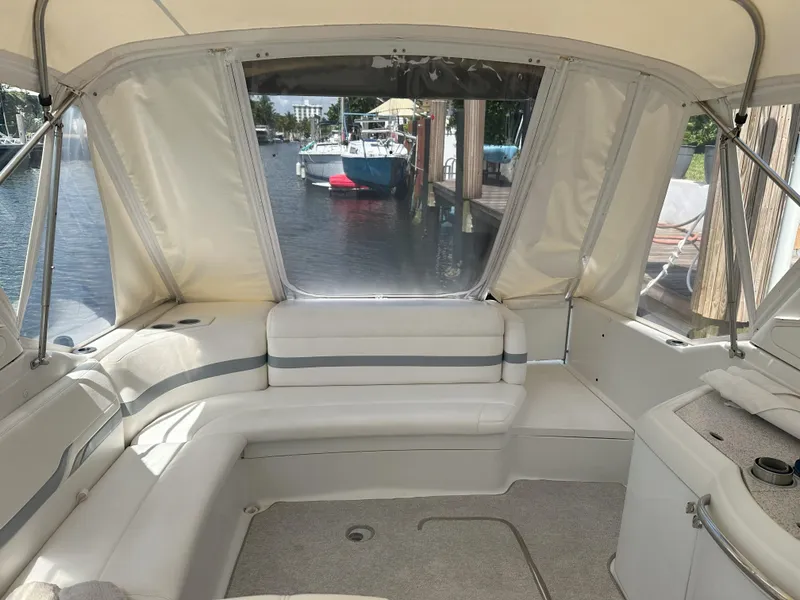 Slide: The Image of Interior of a 2004 Formula 330 SS boat with white seating and waterfront view. - 12