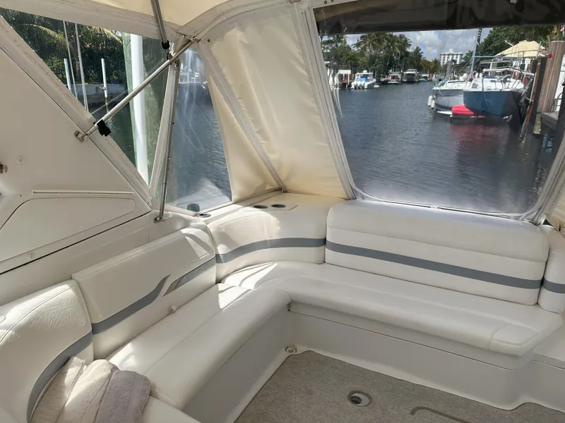Slide: The Image of Interior of a 2004 Formula 330 SS boat with white seating and waterfront view. - 13