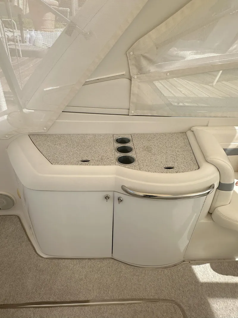 Slide: The Image of Interior view of a 2004 Formula 330 SS boat with cup holders and storage. - 14