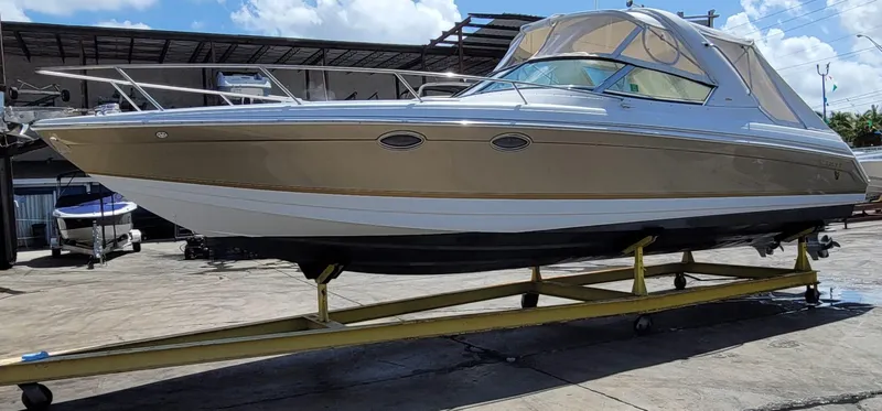Slide: The Image of 2004 Formula 330 SS boat on trailer in a marina. - 2