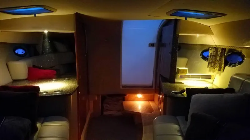 Slide: The Image of Interior cabin of a 2004 Formula 330 SS boat, dimly lit with cozy seating. - 23