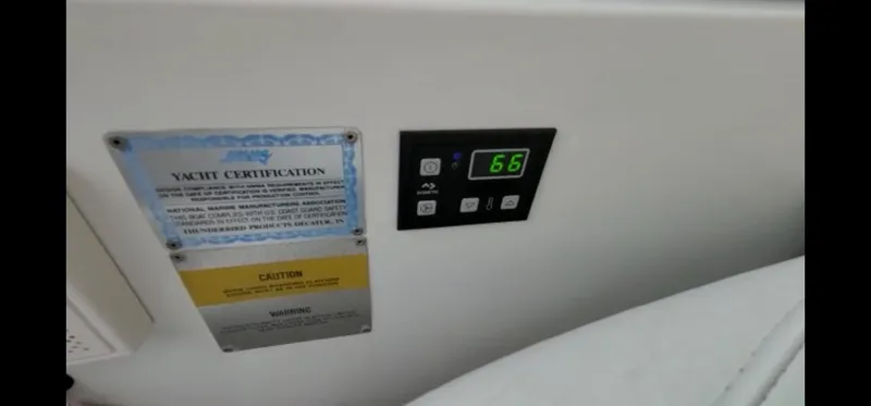 Slide: The Image of Engine room of a 2004 Formula 330 Sun Sport boat, featuring red machinery and wiring. - 28