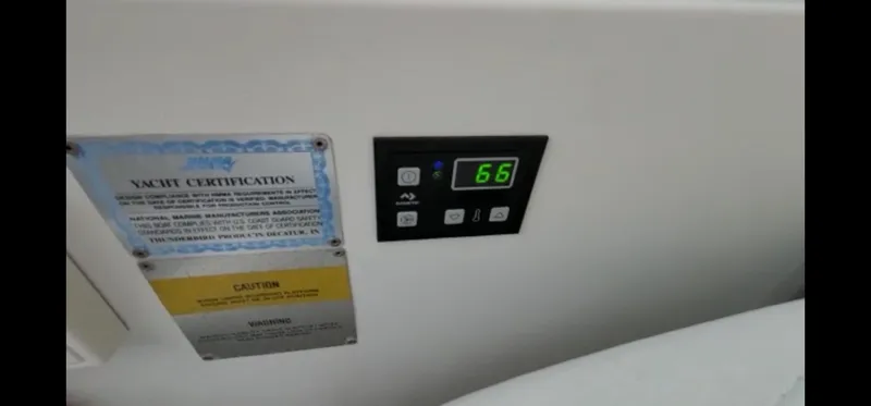 Slide: The Image of Control panel and certification on a 2004 Formula 330 SS yacht. - 29