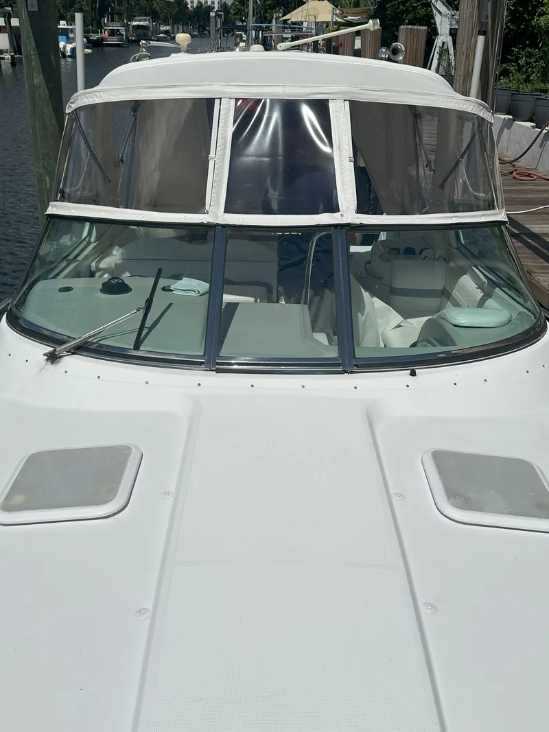 Slide: The Image of 2004 Formula 330 SS boat docked, front view with windshield and canopy. - 7