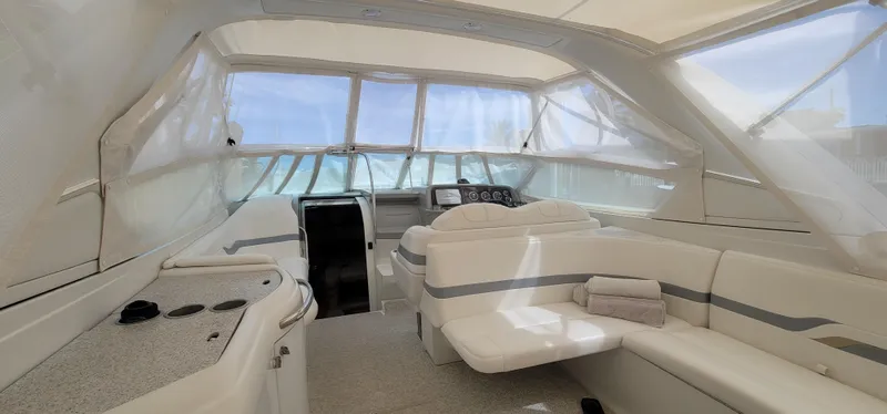 Slide: The Image of Interior of a 2004 Formula 330 SS boat with white seating and helm. - 9