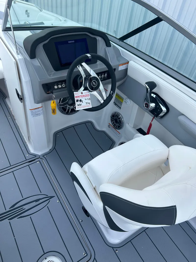 Slide: The Image of 2024 Chaparral 21 Surf boat cockpit with steering wheel and control panel. - 10