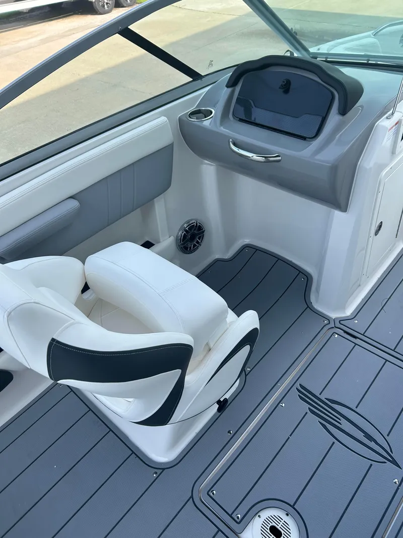 Slide: The Image of 2024 Chaparral 21 Surf boat interior with white and gray seating and dashboard. - 12
