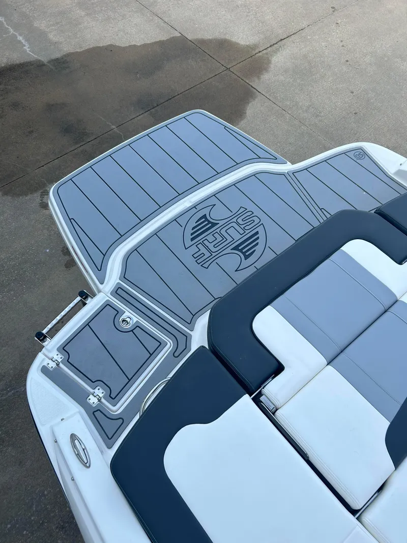 Slide: The Image of 2024 Chaparral 21 Surf boat with gray and white seating and deck. - 7