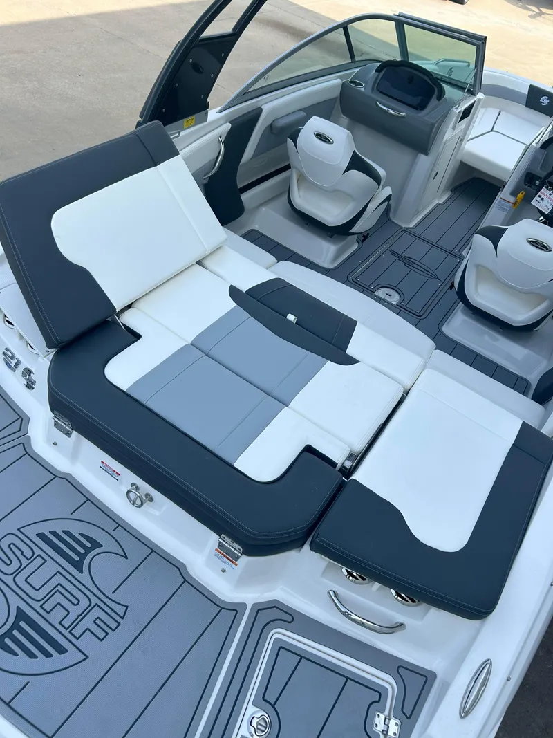 Slide: The Image of 2024 Chaparral 21 Surf boat interior with white and gray seating. - 8