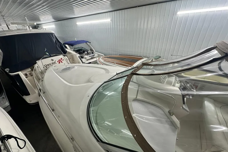 Slide: The Image of 1998 Cruisers Yachts 3075 Rogue stored indoors with other boats. - 16