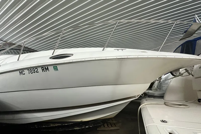 Slide: The Image of 1998 Cruisers Yachts 3075 Rogue in storage, side view under metal roof. - 18