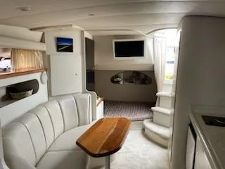 Slide: The Image of 1998 Cruisers Yachts 3075 Rogue interior with white seating and colorful cushions. - 6