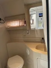 Slide: The Image of 1998 Cruisers Yachts 3075 Rogue interior kitchen with cabinets, microwave, and sink. - 9