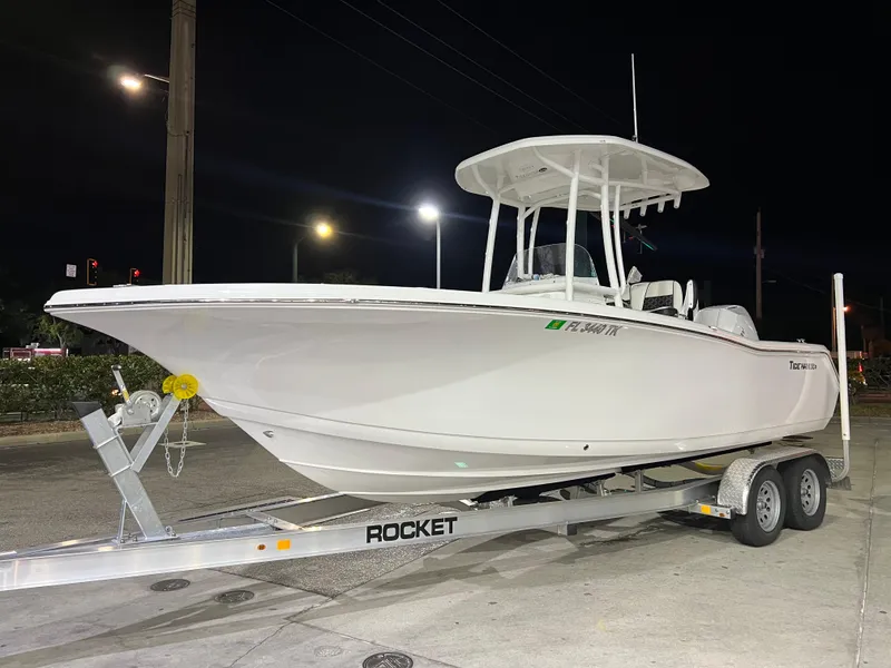 Slide: The Image of 2023 Tidewater 220 CC Adventure boat anchored near a shoreline. - 11