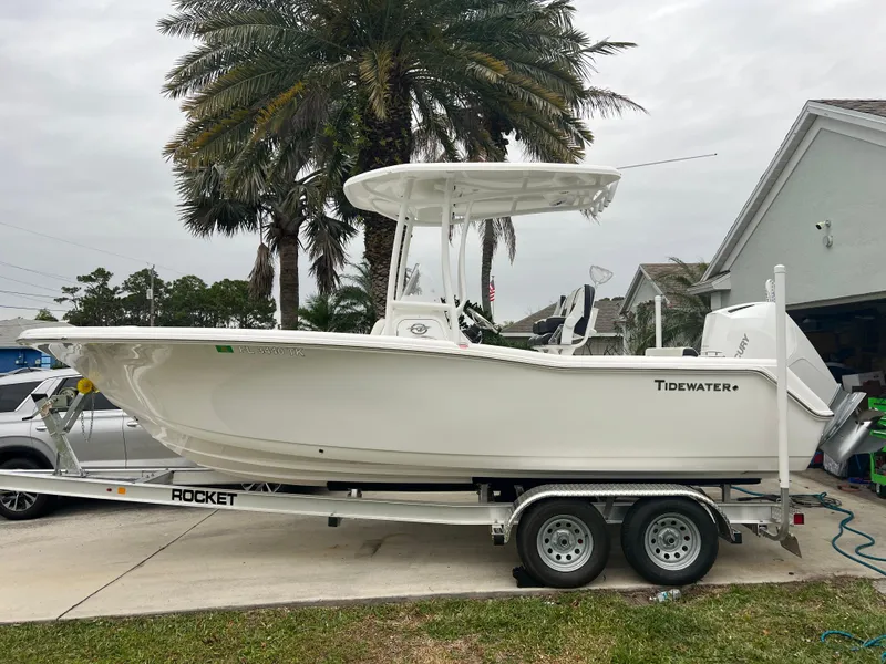 Slide: The Image of 2023 Tidewater 220 CC Adventure boat cockpit with steering wheel and control panel. - 12