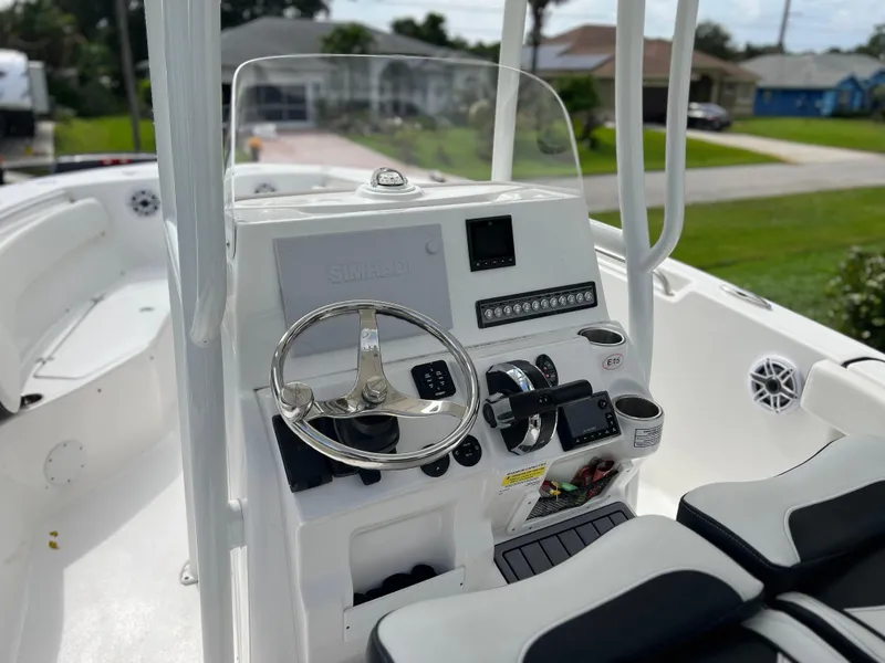 Slide: The Image of 2023 Tidewater 220 CC Adventure boat with dual cushioned seats. - 13