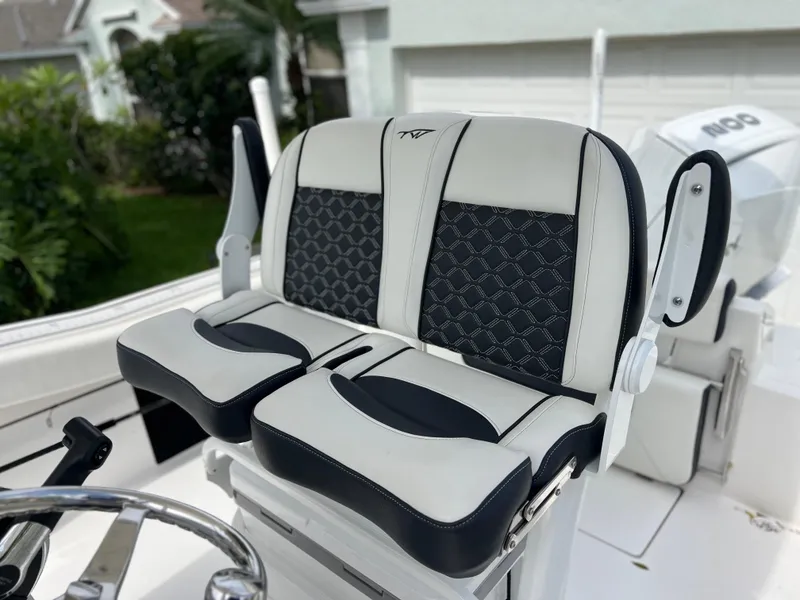 Slide: The Image of 2023 Tidewater 220 CC Adventure boat seat with white and black upholstery. - 14