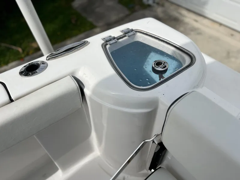 Slide: The Image of 2023 Tidewater 220 CC Adventure boat console with steering wheel and electronic controls. - 20