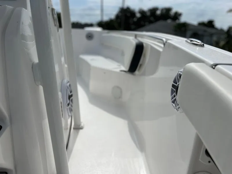 Slide: The Image of 2023 Tidewater 220 CC Adventure boat interior with white seating and storage compartments. - 26