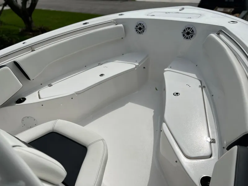 Slide: The Image of 2023 Tidewater 220 CC Adventure boat interior seating with black and white upholstery. - 27