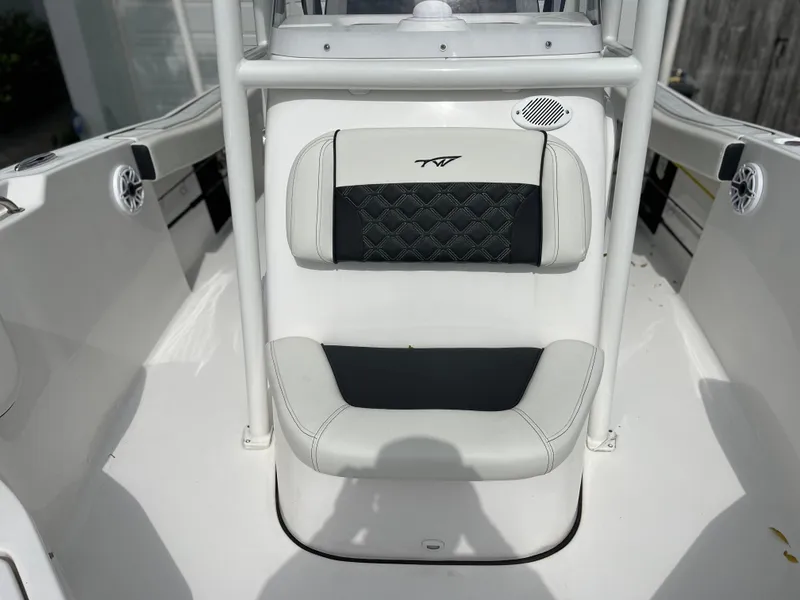 Slide: The Image of 2023 Tidewater 220 CC Adventure boat interior detail with cushioned seating and cup holder. - 28