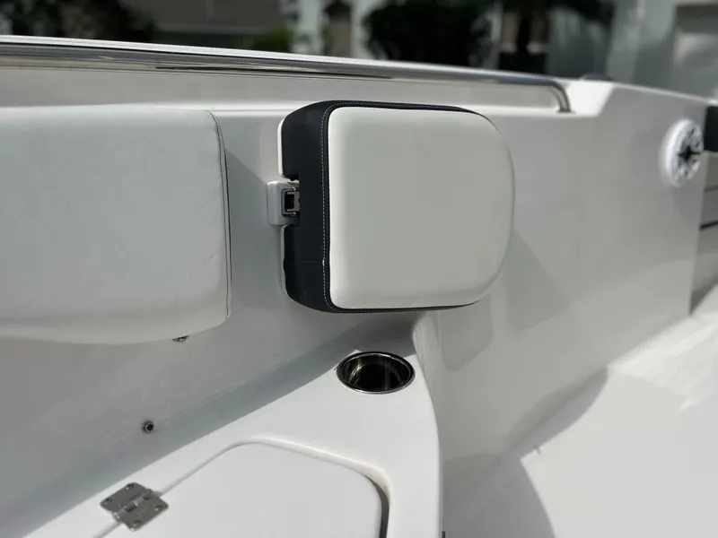 Slide: The Image of 2023 Tidewater 220 CC Adventure boat interior with cushioned seating and cup holder. - 29