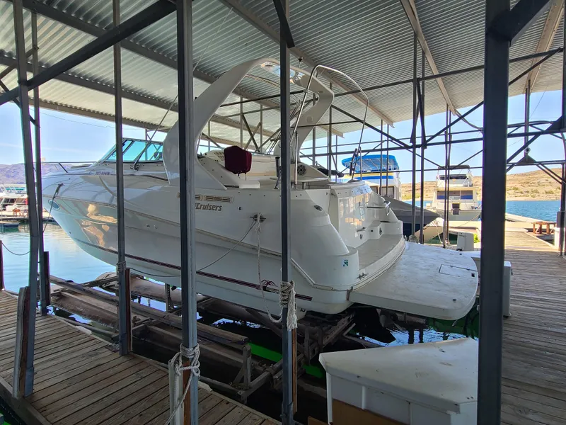 Slide: The Image of 1995 Cruisers Rogue boat docked in a covered marina. - 1
