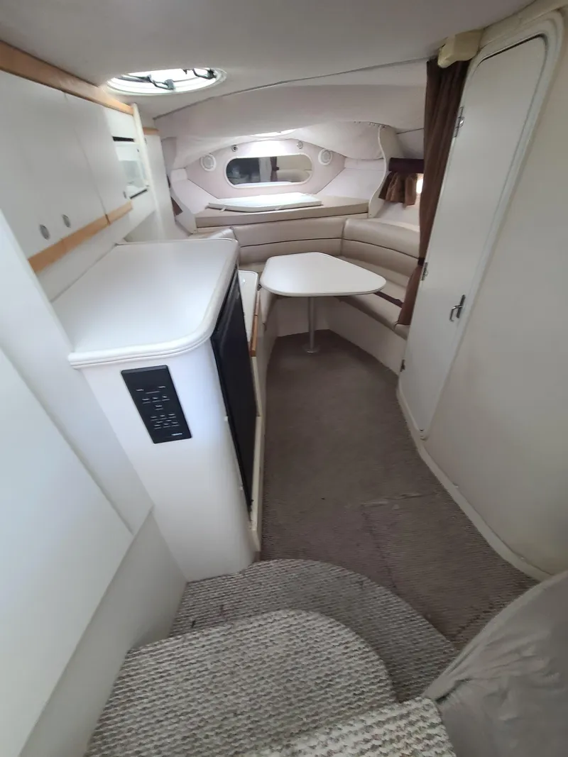 Slide: The Image of Interior of a 1995 Cruisers Rogue boat with seating area and table. - 12