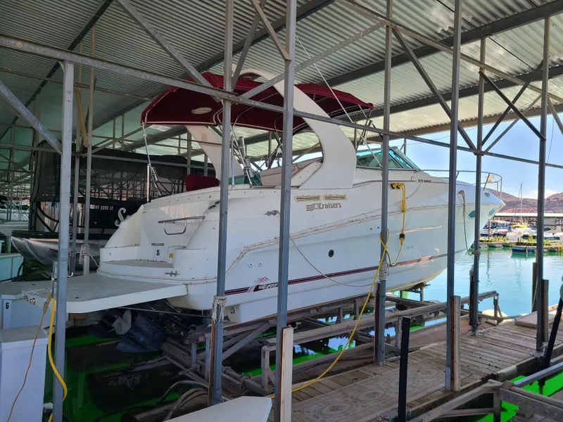 Slide: The Image of 1995 Cruisers Rogue boat docked in a covered marina. - 3