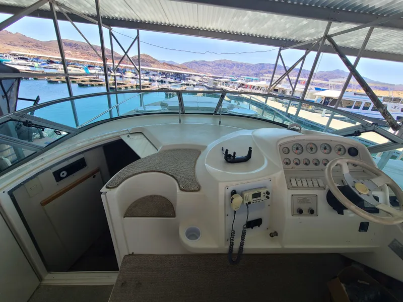 Slide: The Image of 1995 Cruisers Rogue boat helm with marina view. - 8