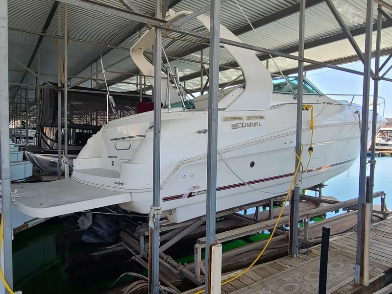 The Image of 1995 Cruisers Rogue boat docked in a covered marina. - 0