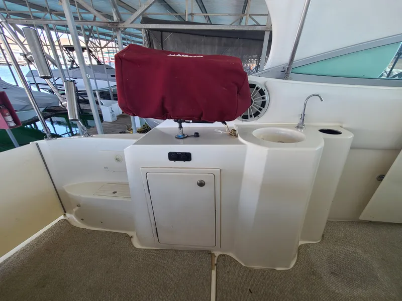 Slide: The Image of 1995 Cruisers Rogue boat interior with sink and covered grill. - 10