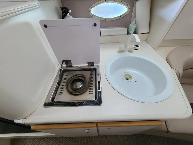 Slide: The Image of 1995 Cruisers Rogue boat kitchenette with stove and sink. - 18