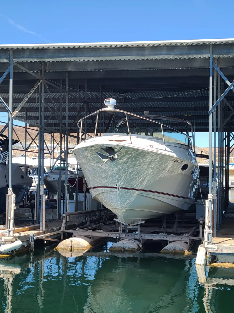 Slide: The Image of 1995 Cruisers Rogue boat docked in a covered marina. - 2