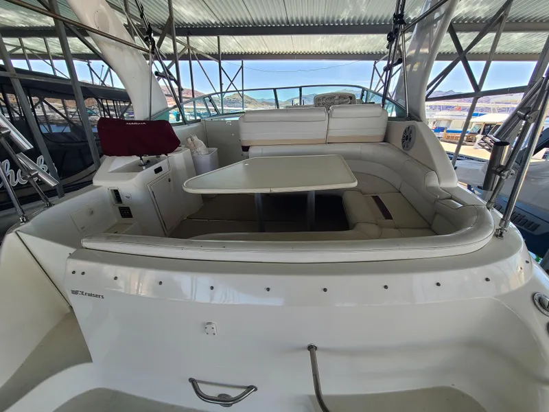 Slide: The Image of 1995 Cruisers Rogue boat interior with seating and table under a canopy. - 6