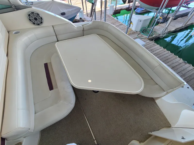 Slide: The Image of 1995 Cruisers Rogue boat interior with white seating and table. - 9