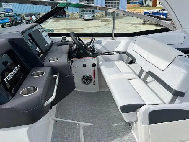 Slide: The Image of 2025 Formula 330 Crossover Bowrider I/O cockpit with modern dashboard and seating. - 13