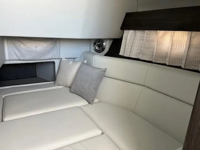 Slide: The Image of 2025 Formula 330 Crossover Bowrider I/O cabin interior with white leather seating and pillows. - 20
