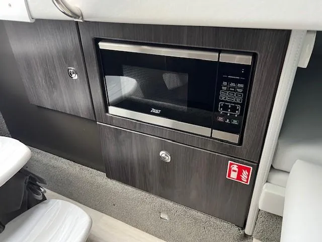 Slide: The Image of Microwave in 2025 Formula 330 Crossover Bowrider I/O boat interior. - 22