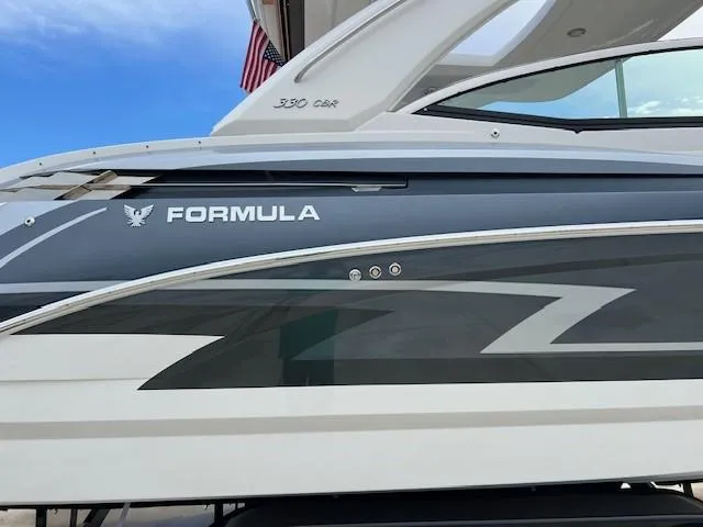 Slide: The Image of 2025 Formula 330 Crossover Bowrider I/O side view with sleek design and branding. - 4
