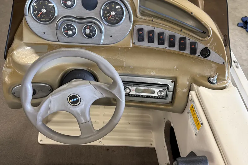 Slide: The Image of 2007 Crestliner 2185 Batata Bay boat dashboard with steering wheel and control panel. - 10