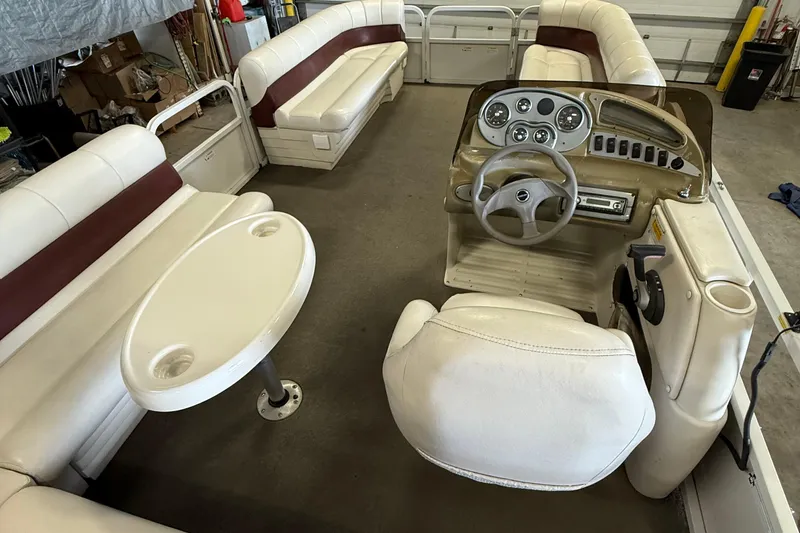 Slide: The Image of 2007 Crestliner 2185 Batata Bay boat interior with white seating and steering console. - 11