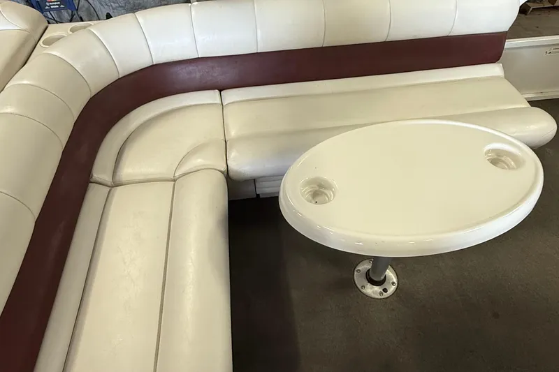 Slide: The Image of 2007 Crestliner 2185 Batata Bay boat interior with white and maroon seating, oval table. - 12