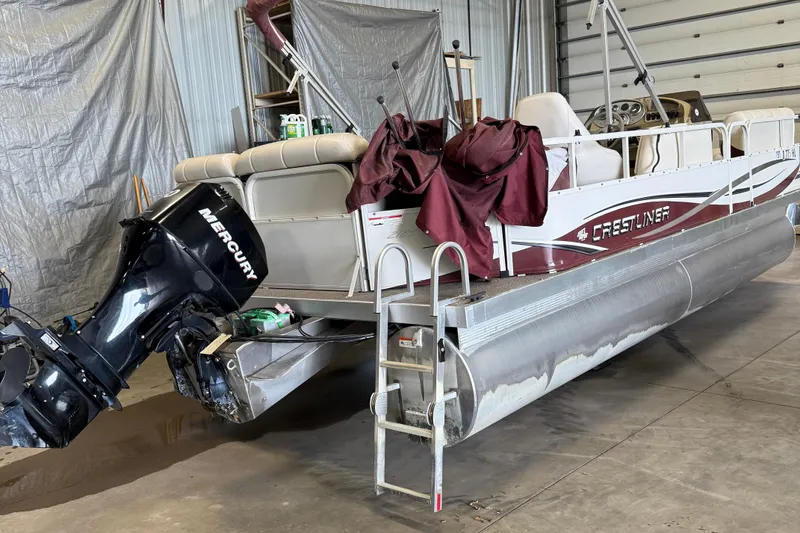Slide: The Image of 2007 Crestliner 2185 Batata Bay pontoon boat with Mercury outboard motor in a garage. - 3