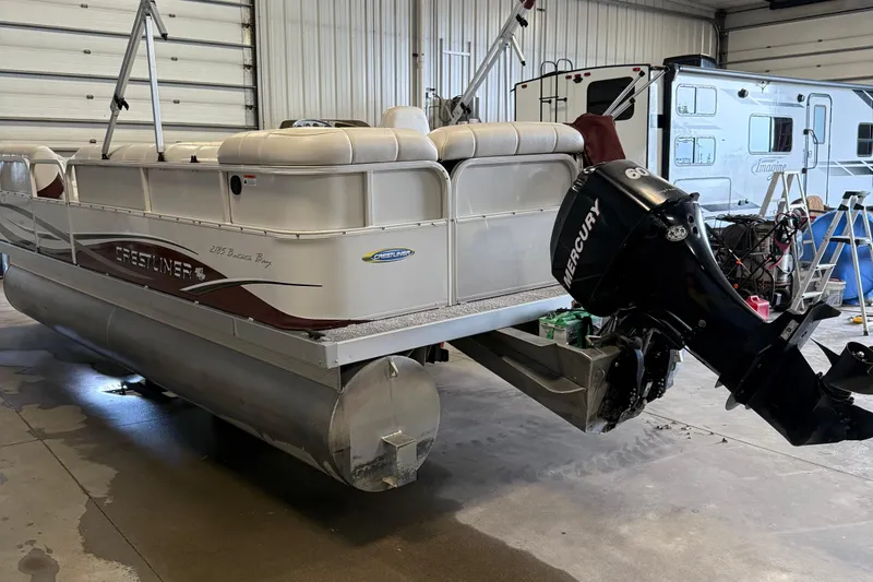 Slide: The Image of 2007 Crestliner 2185 Batata Bay pontoon boat with Mercury outboard motor in a garage. - 4