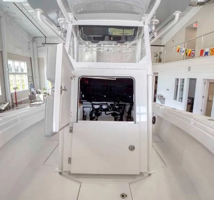 Slide: The Image of 2025 Onslow Bay 27 Offshore Edition boat interior with open console in showroom. - 10