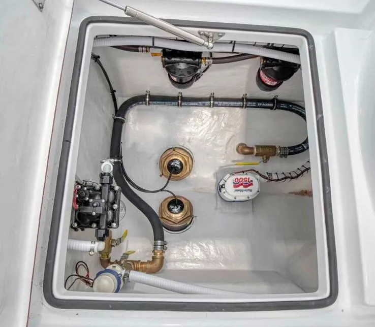 Slide: The Image of Onslow Bay 27 Offshore Edition 2025 boat bilge compartment with pumps and plumbing. - 12