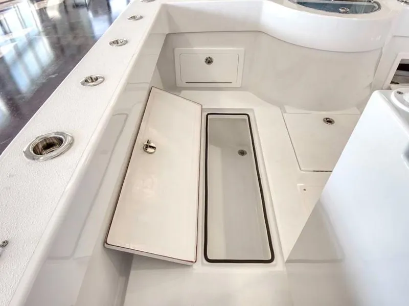 Slide: The Image of 2025 Onslow Bay 27 Offshore Edition boat interior with open storage compartments. - 15