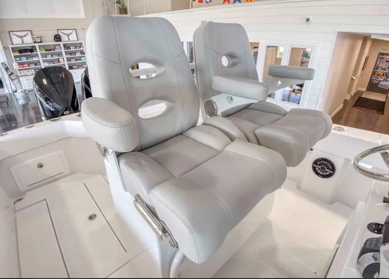 Slide: The Image of 2025 Onslow Bay 27 Offshore Edition boat with luxurious dual captain's chairs. - 17