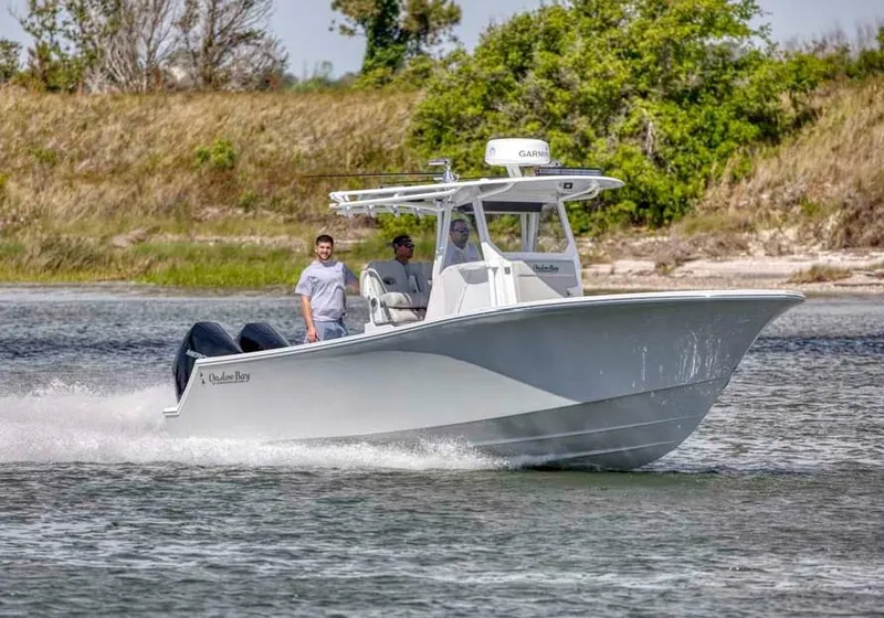 Slide: The Image of 2025 Onslow Bay 27 Offshore Edition boat cruising on a calm waterway. - 18